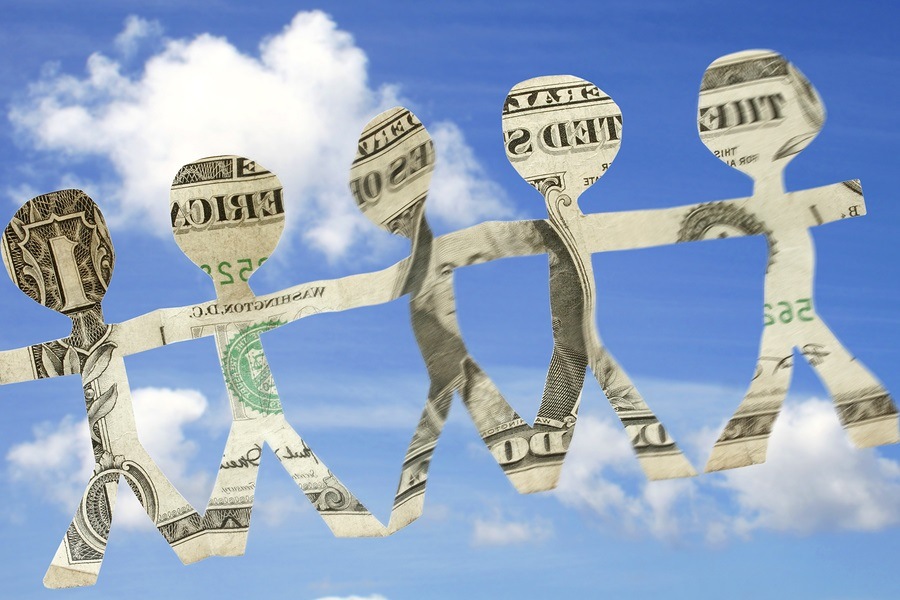 Paper children made of money with blue sky