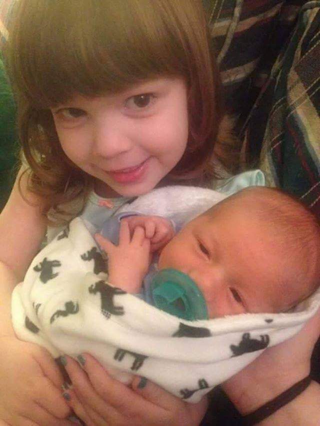 Holly Baylee holding baby brother