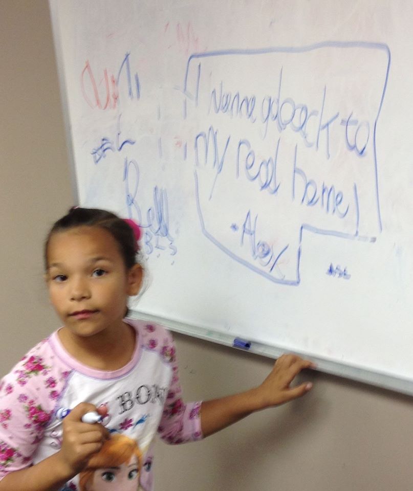 The children write and draw on a board during visits. Alex wrote on the board at the 10/24/16 visitation, "I wanna go back to my real home! - Alex" (Photo provided by family)