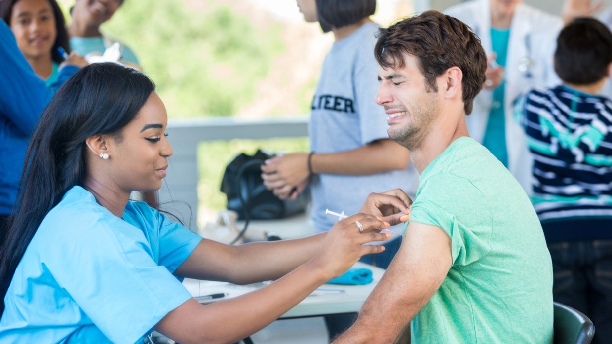 black-nurse-injecting-white-man